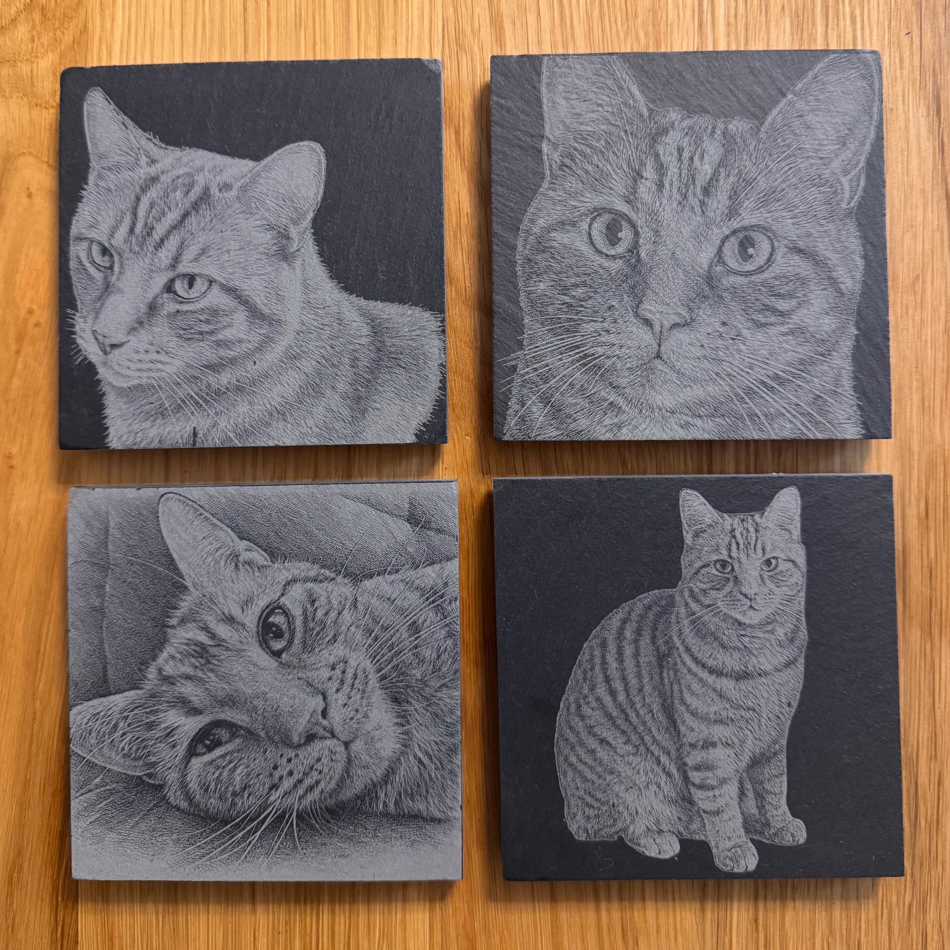 Set of four slate coasters with engraved cat portraits, perfect for cat lovers and unique gifts.