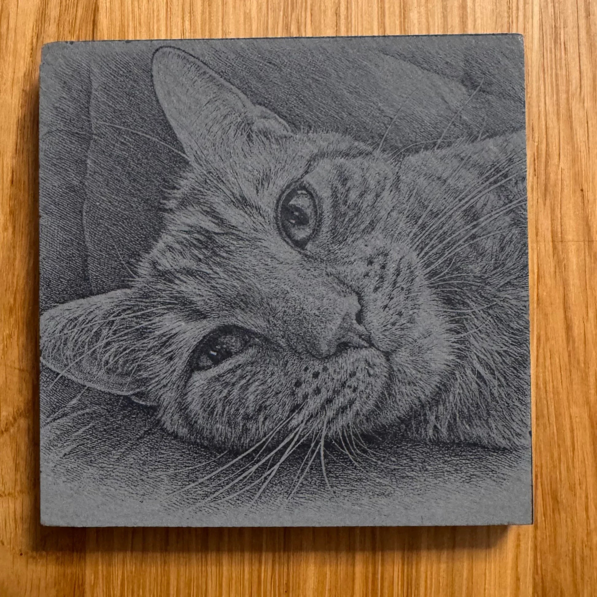 Slate coaster with engraved cat portrait, perfect for pet lovers and unique home decor.