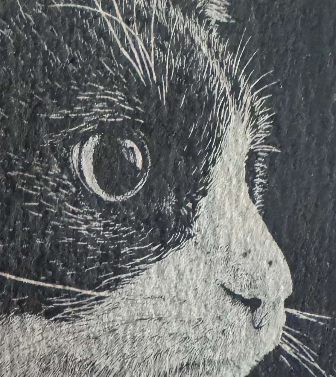 Handcrafted slate coaster with detailed cat face engraving, perfect for pet lovers.