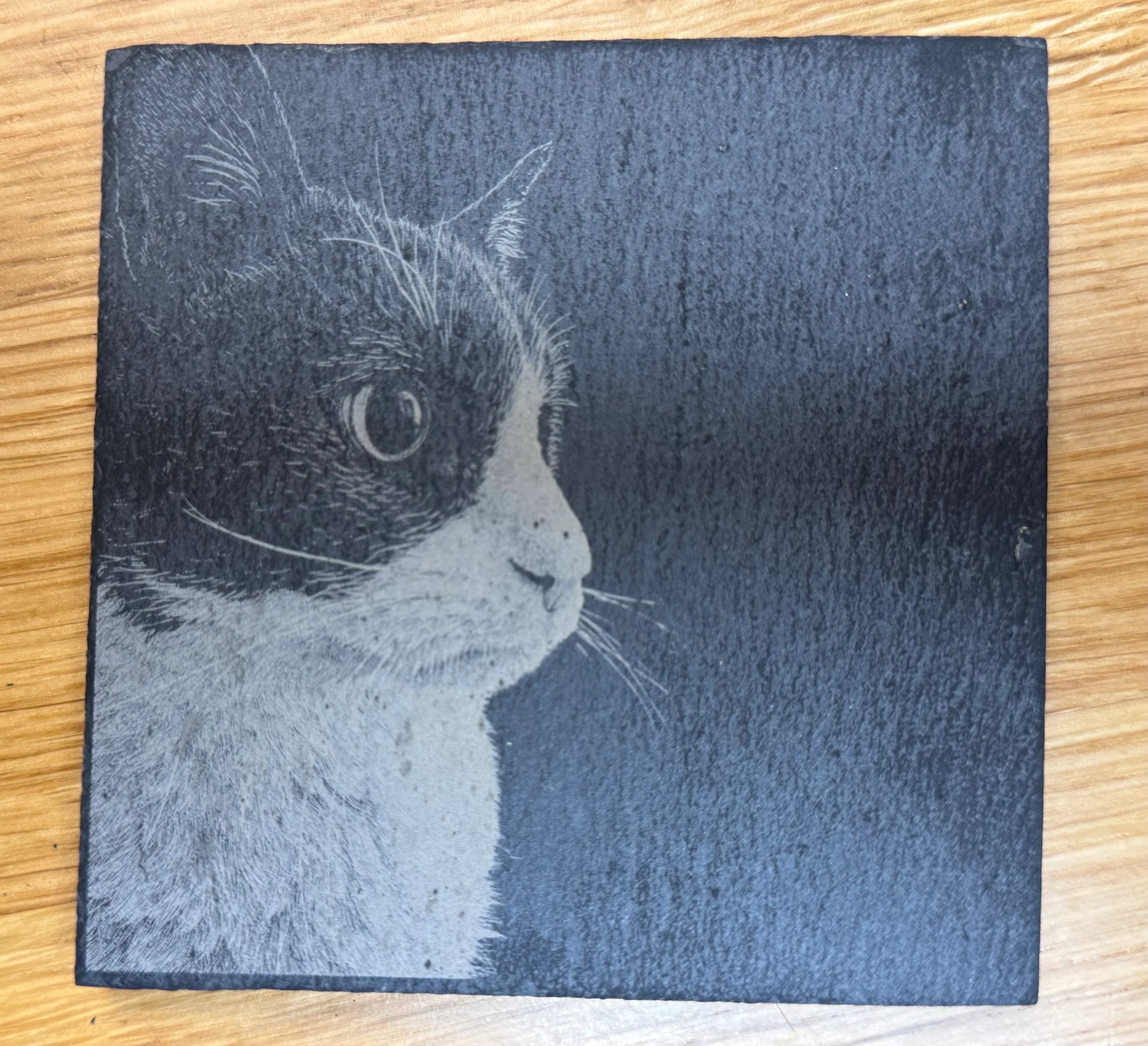 Slate coaster with engraved cat portrait, perfect for pet lovers and unique gifts.