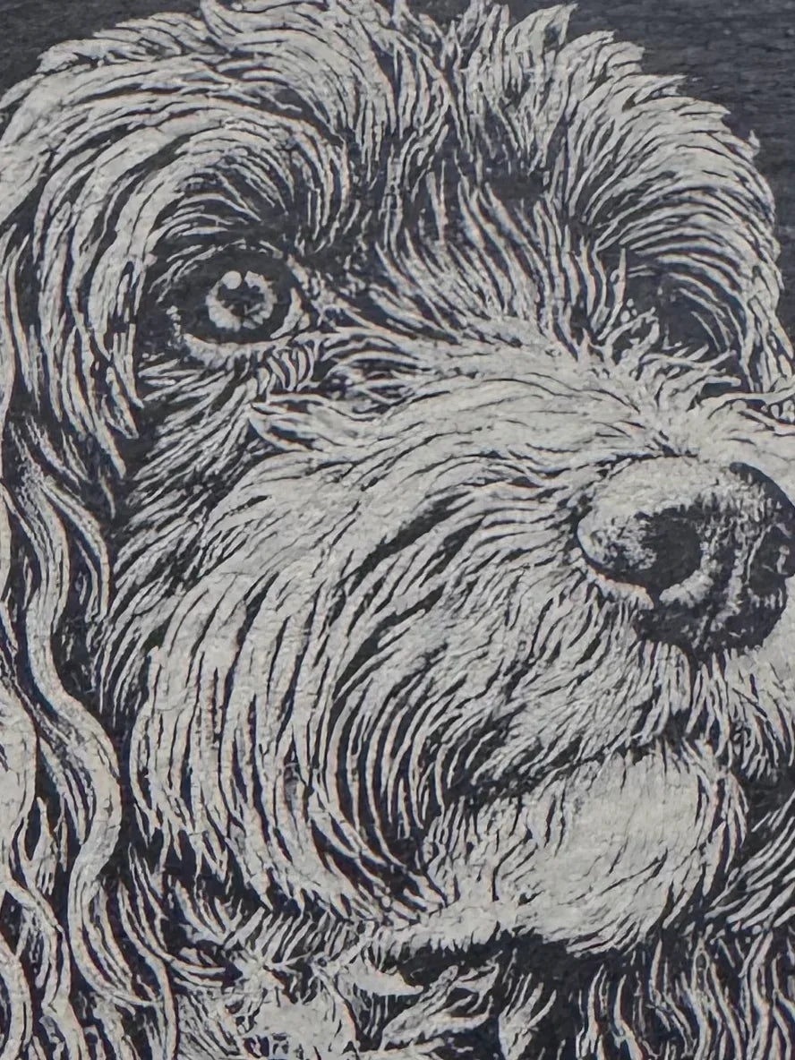 Handcrafted dog portrait etched in slate, perfect for unique personalized gifts.