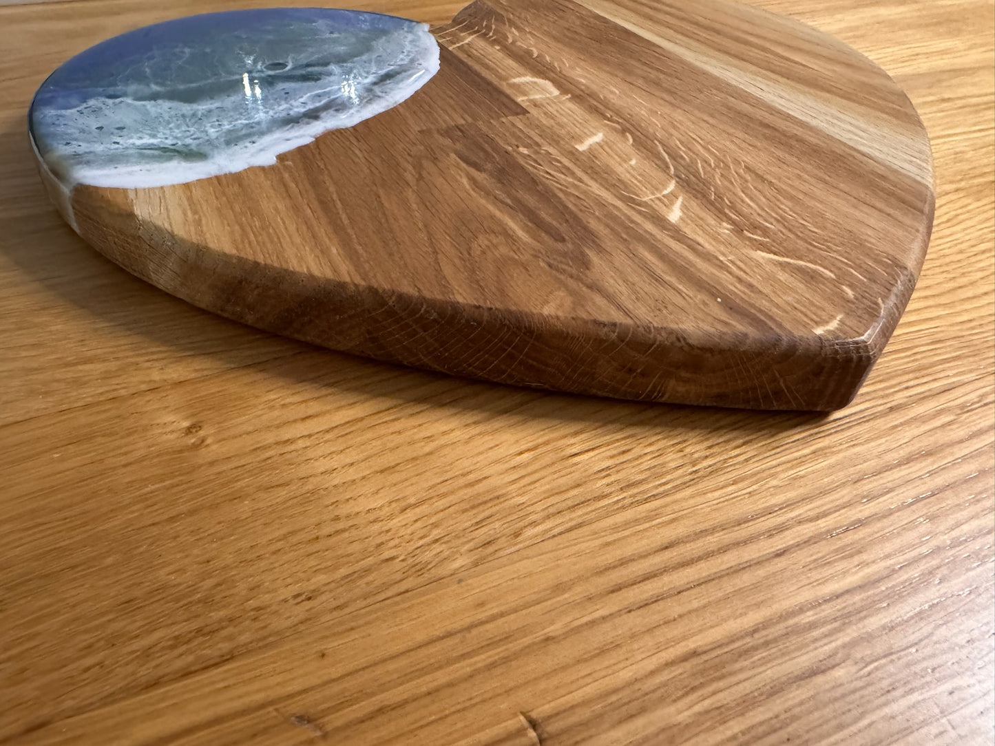 Handcrafted oak serving board with resin ocean wave design, perfect for unique home decor or gifts