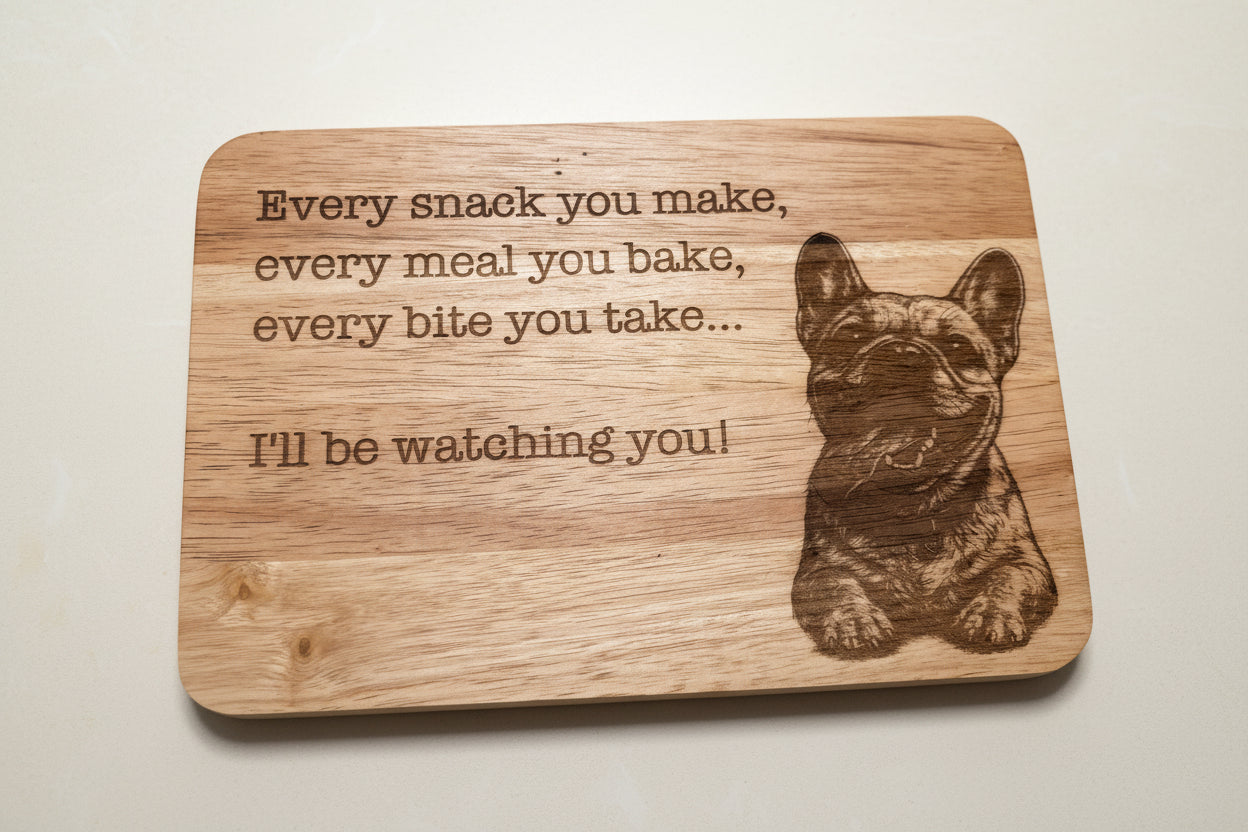 Wooden cutting board with a dog illustration and text on a wooden surface